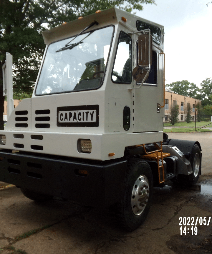 Side-front view of a Capacity yard truck. Renew Truck in New Boston, TX remanufactures and repairs yard spotter trucks.