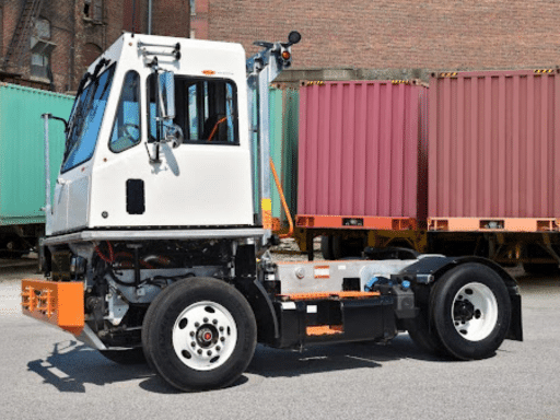 TICO Terminal Tractor Repair Specialist | Renew Truck New Boston. Image of Tico Terminal tractor on cargo yard with containers in the background.