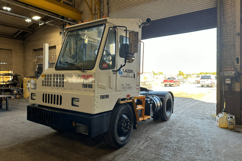 spotter truck repair, spotter truck repair in New Boston, TX at Renew Truck. ReNew Truck refurbished Kalmar Ottawa terminal tractor inside a service bay, ready for yard truck operations and delivery.