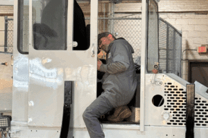 yard truck repair, spotter truck repair in New Boston, TX at Renew Truck. Technician at Renew Truck performing maintenance inside a yard truck in New Boston, TX. Image shows interior diagnostics being conducted on industrial equipment.