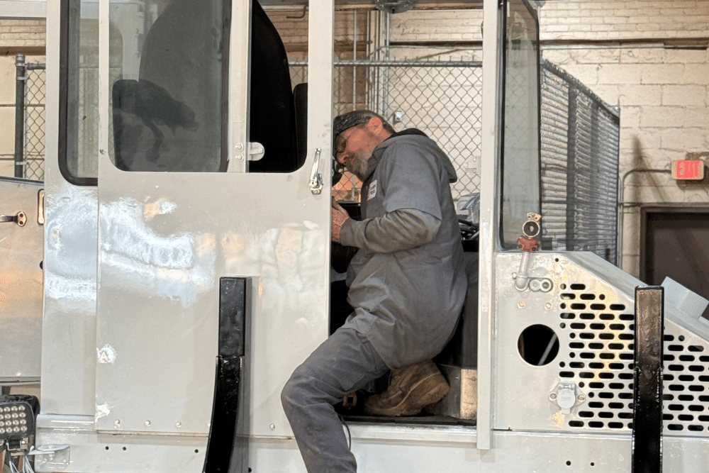 yard truck repair, spotter truck repair in New Boston, TX at Renew Truck. Technician at Renew Truck performing maintenance inside a yard truck in New Boston, TX. Image shows interior diagnostics being conducted on industrial equipment.